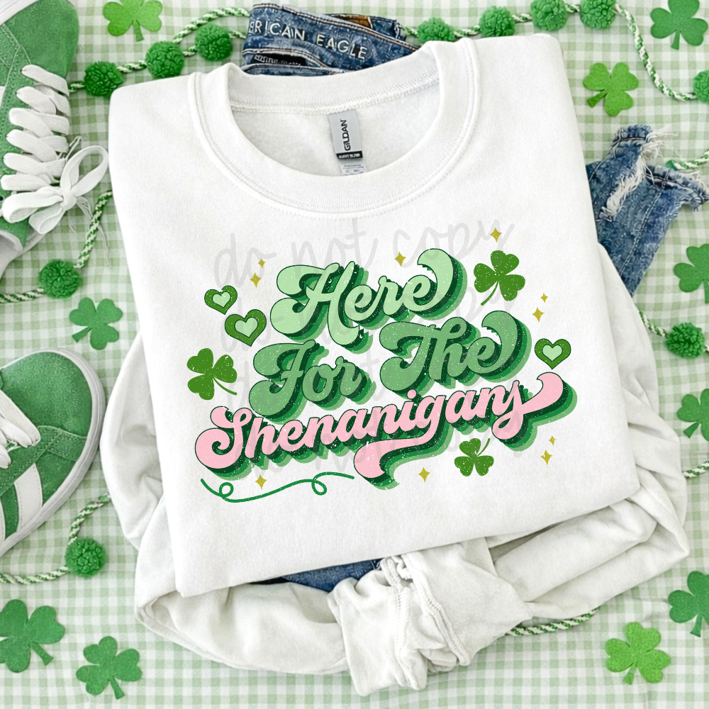 Here for the Shenanigans St. Patrick’s Day graphic tee with retro green and pink script lettering and shamrock accents on white Bella Canvas or Comfort Colors shirt.